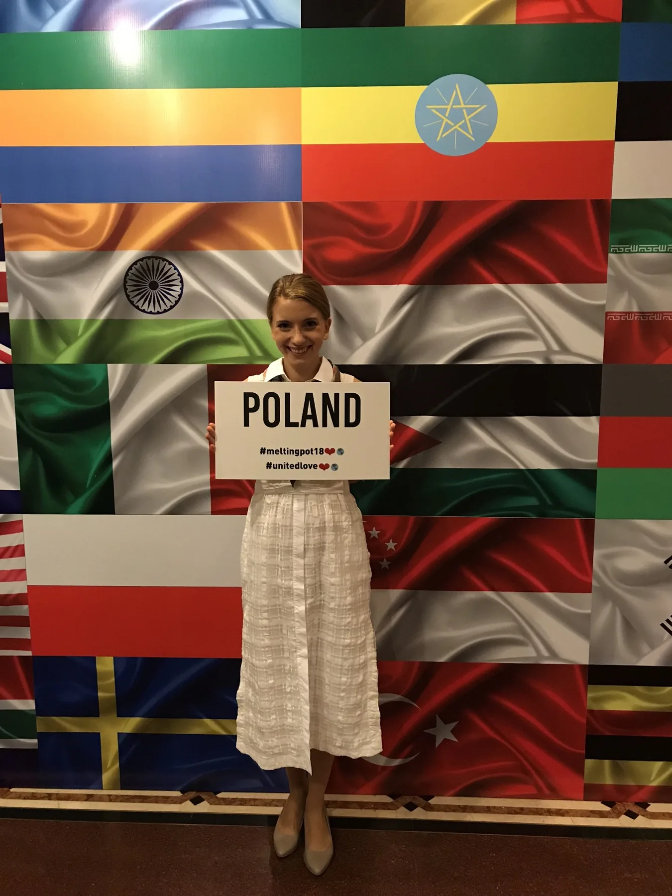 Ada Dyndo in front of the flags of Poland, India and other countries